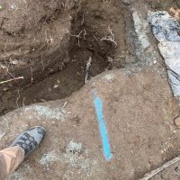 a hole dug in the ground revealing the water line